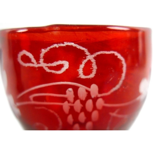 550 - A Bohemian ruby engraved goblet decorated with opposing C scrolls with cross hatching, a house and a... 