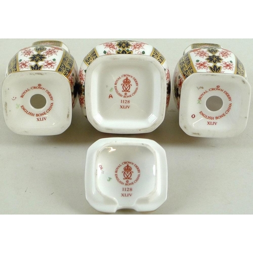 563 - A Royal Crown Derby cruet set, in the Imari pattern number 1128, comprising salt and pepper shakers,... 