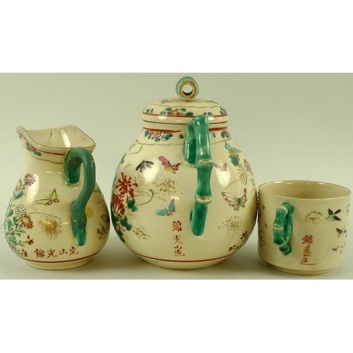 566 - A Japanese stoneware part tea service, early 20th century, modelled with faux bamboo green painted h... 