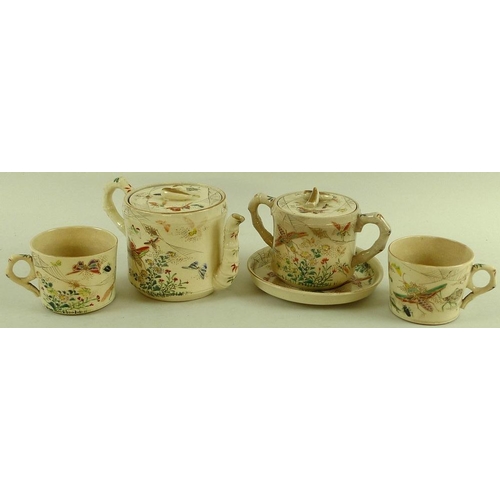 566 - A Japanese stoneware part tea service, early 20th century, modelled with faux bamboo green painted h... 