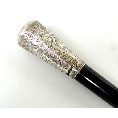 701 - A George IV ebonised vanity cane, the silver pommel engraved with scrolling foliage, Chester 1827, 5... 