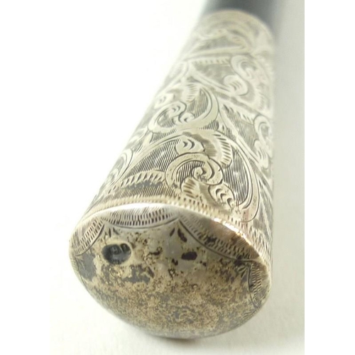 701 - A George IV ebonised vanity cane, the silver pommel engraved with scrolling foliage, Chester 1827, 5... 