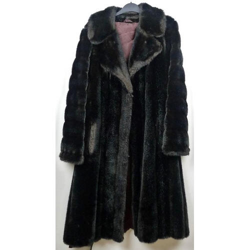 716 - Two fur coats, one a grey Angora example with belt, the other a black fur longcoat. (2)