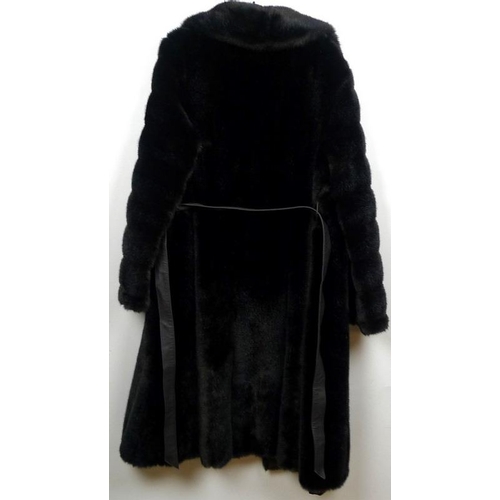 716 - Two fur coats, one a grey Angora example with belt, the other a black fur longcoat. (2)