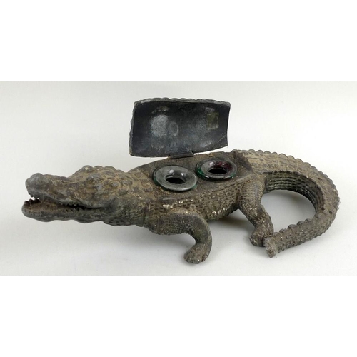 764 - An Edwardian novelty cast metal inkwell, in form of a crocodile, painted green, a portion of the bac... 