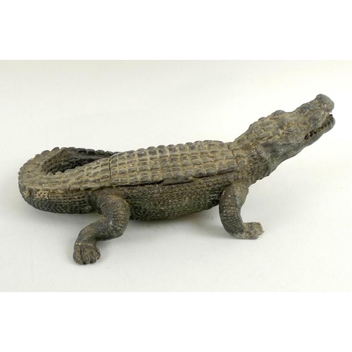 764 - An Edwardian novelty cast metal inkwell, in form of a crocodile, painted green, a portion of the bac... 