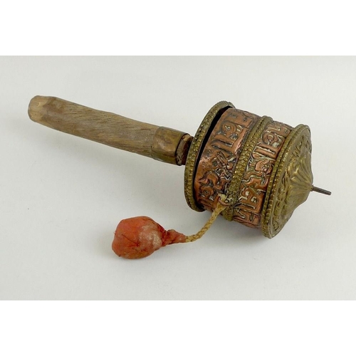 765 - A Tibetan copper and brass prayer wheel, early 20th century, 8.5 by 25cm. Provenance: The Estate of ... 