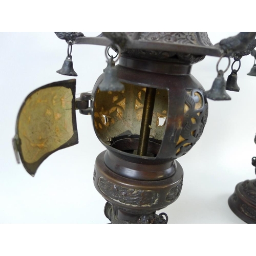 769 - A pair of early 20th century Chinese bronze freestanding lanterns, with removable hexagonal bell sha... 