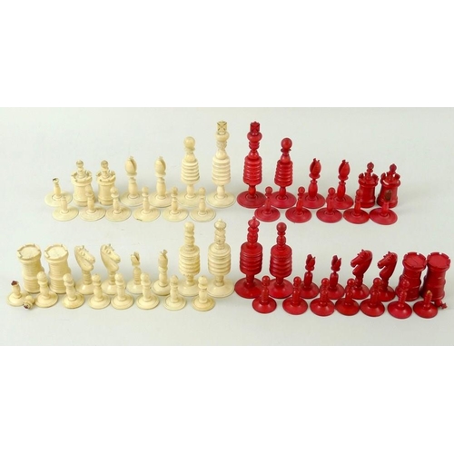 770 - A quantity of plain and red stained ivory chess pieces, early 20th century, from two different sets,... 