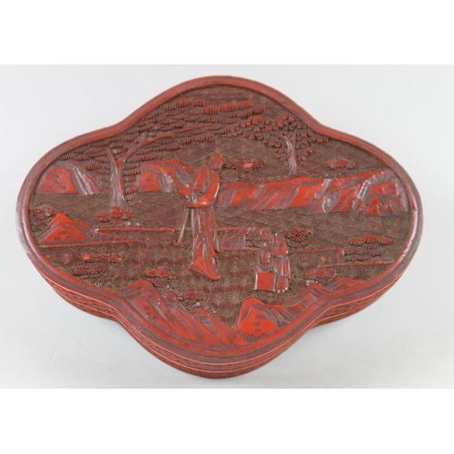 774 - A pair of Chinese cinnabar lacquer boxes, of quatrefoil forms, the lid of each carved with mirror im... 