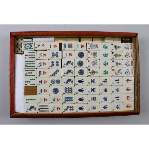 787 - A mah jong set with bamboo and bone, the tiles with multi coloured motifs, boxed, with Chinese chara... 