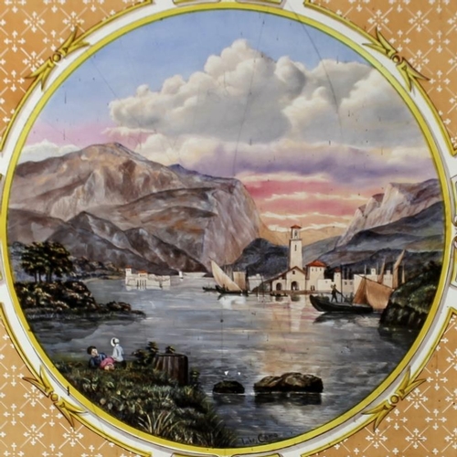 789 - A 19th century painted glass panel, depicting an Italian lake scene, with orange and blue borders an... 