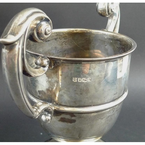 797 - Three Edwardian silver trophies, the first with two angular handles framing elongated body, beaded k... 