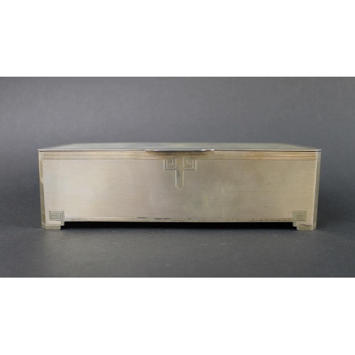 809 - A silver Art Deco cigarette box, Greek key design to edges of engine turned body, gilded interior of... 