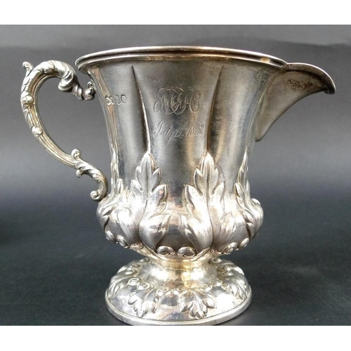 817 - A collection of silver, comprising a Victorian milk jug, the scalloped body chased and embossed with... 