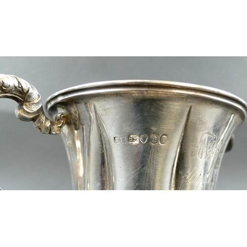 817 - A collection of silver, comprising a Victorian milk jug, the scalloped body chased and embossed with... 