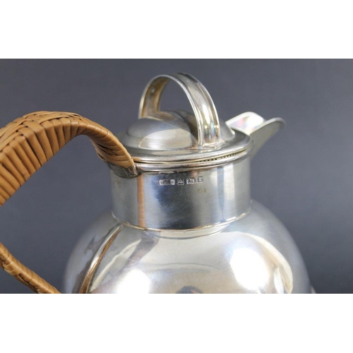 819 - A silver Guernsey creamer of conventional form with rattan wrapped handle, Birmingham 1929, Walker a... 