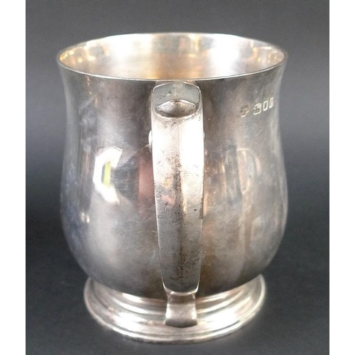 821 - A pair of George VI silver tankards, of rounded bellied form with ribbed feet, C-scrolls handles, Go... 