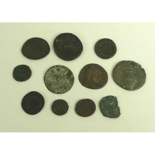 832 - A group of eleven ancient hammered World coins, copper and bronze, including Roman Claudius and Cons... 