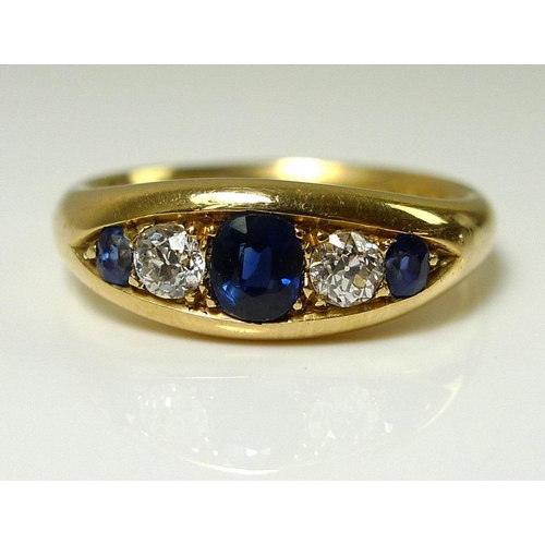 842 - An 18ct gold, diamond and sapphire five stone ring, the central oval cut sapphire 5 by 4mm, total di... 