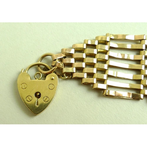 849 - A 9ct gold seven bar gate link bracelet with graduated ends to a heart shaped padlock clasp, 16g.