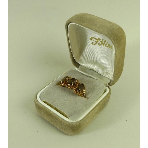 865 - A 9ct gold and yellow topaz ring, the three oval stones each 7.7 by 5.2 by 3.3mm and mounted in a ro... 