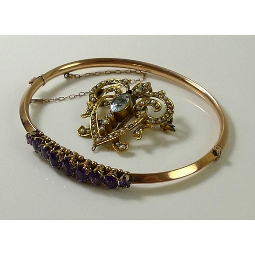 876 - A Victorian rose gold bangle set with nine oval cut amethysts, largest stone 6.3 by 3.5mm, one stone... 