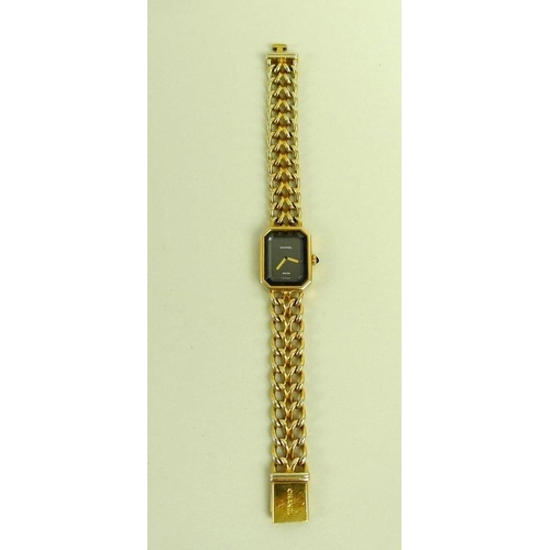 884 - A lady's gold plated Chanel watch, circa 1990, with black rectangular face with canted corners, gold... 