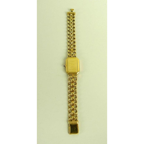 884 - A lady's gold plated Chanel watch, circa 1990, with black rectangular face with canted corners, gold... 