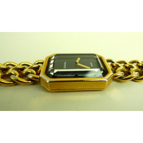 884 - A lady's gold plated Chanel watch, circa 1990, with black rectangular face with canted corners, gold... 