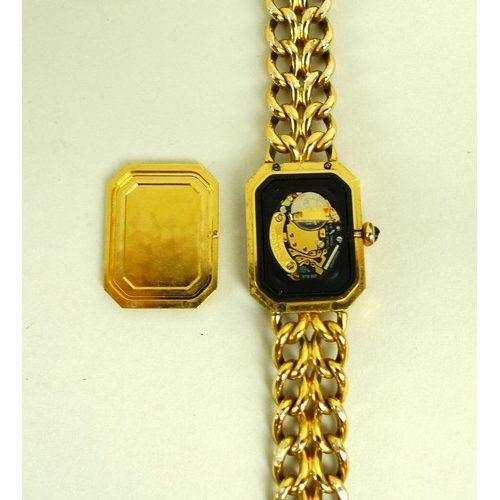 884 - A lady's gold plated Chanel watch, circa 1990, with black rectangular face with canted corners, gold... 