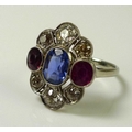 An 18ct white gold, blue sapphire, white sapphire, diamond and ruby dress ring, early to mid 20th ce... 