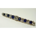 A diamond, sapphire and 9ct gold bar brooch, early 20th century, with central 1.6ct round brilliant ... 