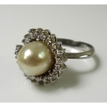 An 18ct white gold, diamond and oval pearl dress ring, total diamond weight approximately 1ct, pearl... 