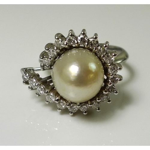 898 - An 18ct white gold, diamond and oval pearl dress ring, total diamond weight approximately 1ct, pearl... 