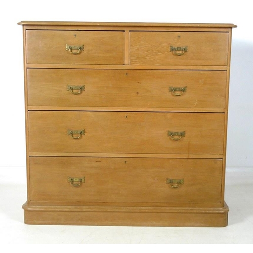 906A - A mid 20th century pine chest of two over three graduating drawers with brass handles, 115 by 52 by ... 