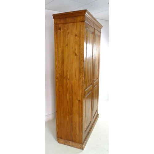 908A - A mid 20th century pitch pine cupboard, two full length doors enclosing four shelves, 127 by 48.5 by... 