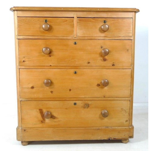 910A - A Victorian pine chest of two short over three long graduating drawers with turned handles, brass es... 