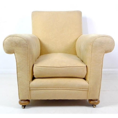 912 - A 20th century cream jacquard upholstered armchair with bun feet, 91 by 80 by 88.5cm high.