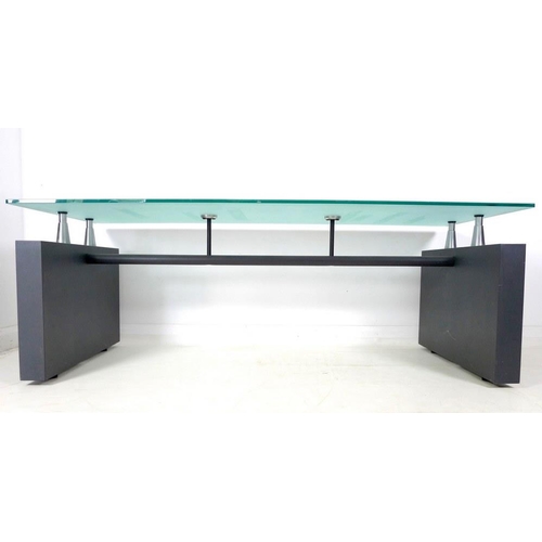 912A - A modern design glass topped dining table, circa 2000, with grey painted steel block shaped supports... 