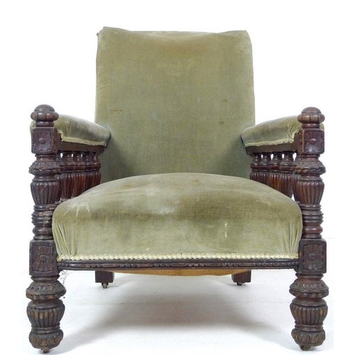 930A - A Victorian oak framed library armchair, circa 1880, with squared back, the padded armrest with turn... 