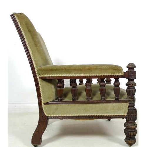 930A - A Victorian oak framed library armchair, circa 1880, with squared back, the padded armrest with turn... 