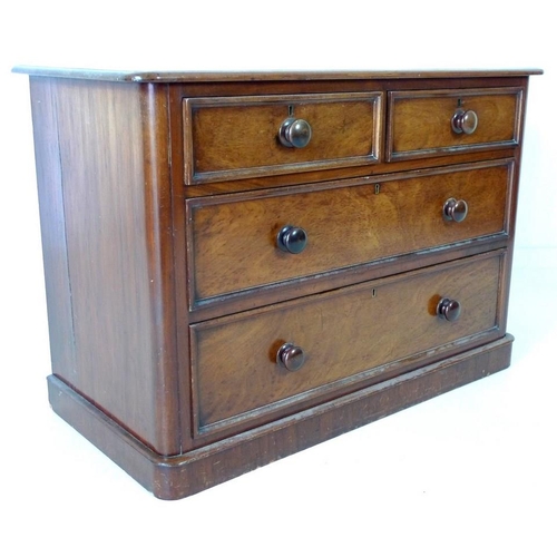 932 - An early Victorian mahogany chest of two over two drawers, with turned handles, raised on plinth bas... 