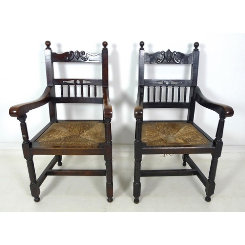 935 - A late 19th century stained oak open armchair, carved crest to the top rail , drop in rush seats, ri... 