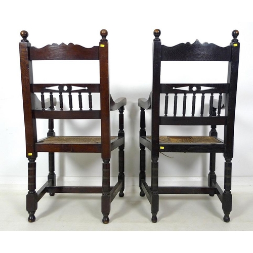 935 - A late 19th century stained oak open armchair, carved crest to the top rail , drop in rush seats, ri... 