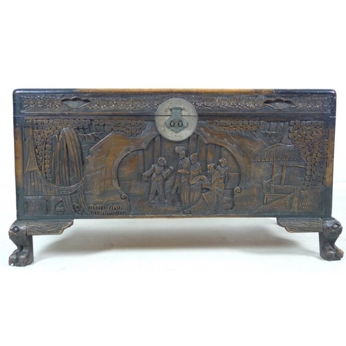 937 - A 20th century carved Chinese camphor wood chest, the body carved with panels depicting figures amid... 