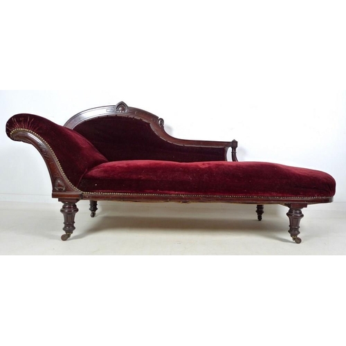 939 - A late Victorian mahogany chaise longue, with carved decoration, turned legs and castors, upholstere... 