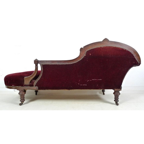 939 - A late Victorian mahogany chaise longue, with carved decoration, turned legs and castors, upholstere... 