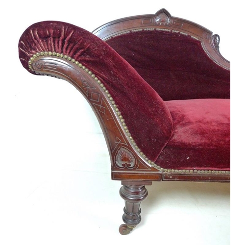 939 - A late Victorian mahogany chaise longue, with carved decoration, turned legs and castors, upholstere... 