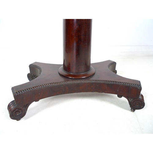 967 - A William IV flame mahogany card table, swivel and fold over surface, raised on a plain gun barrel c... 